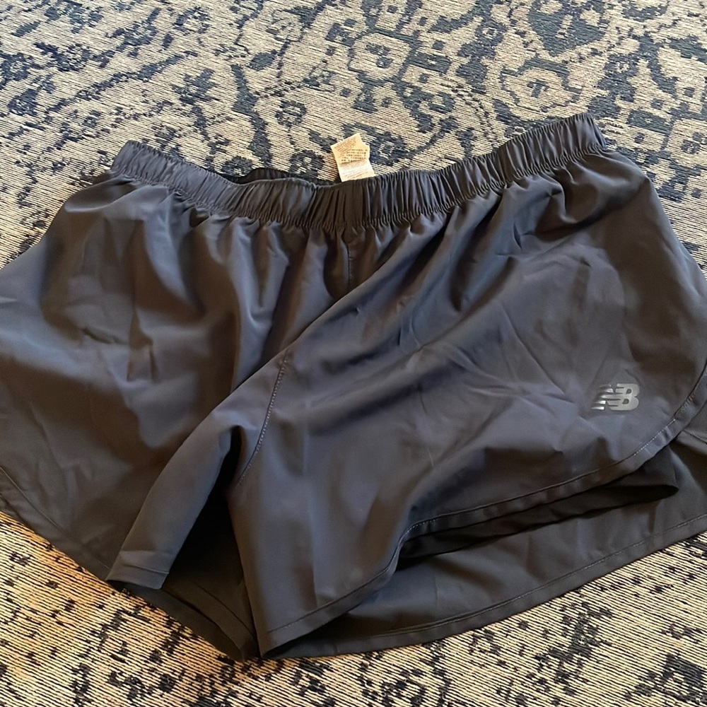 New Balance running shorts with tight shorts under. Never worn!